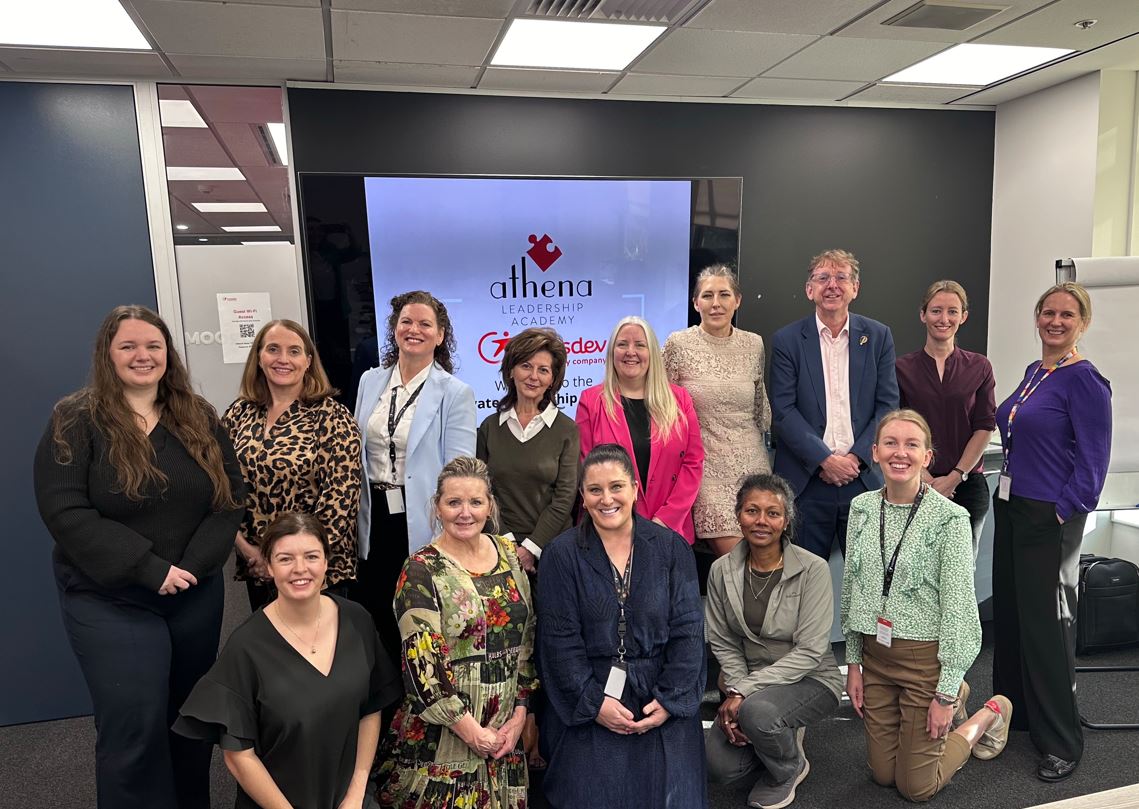 12 female transdev employees and the Transdev Australia and New Zealand CEO Brian Brennan standing in front of a screen that reads "Athena"